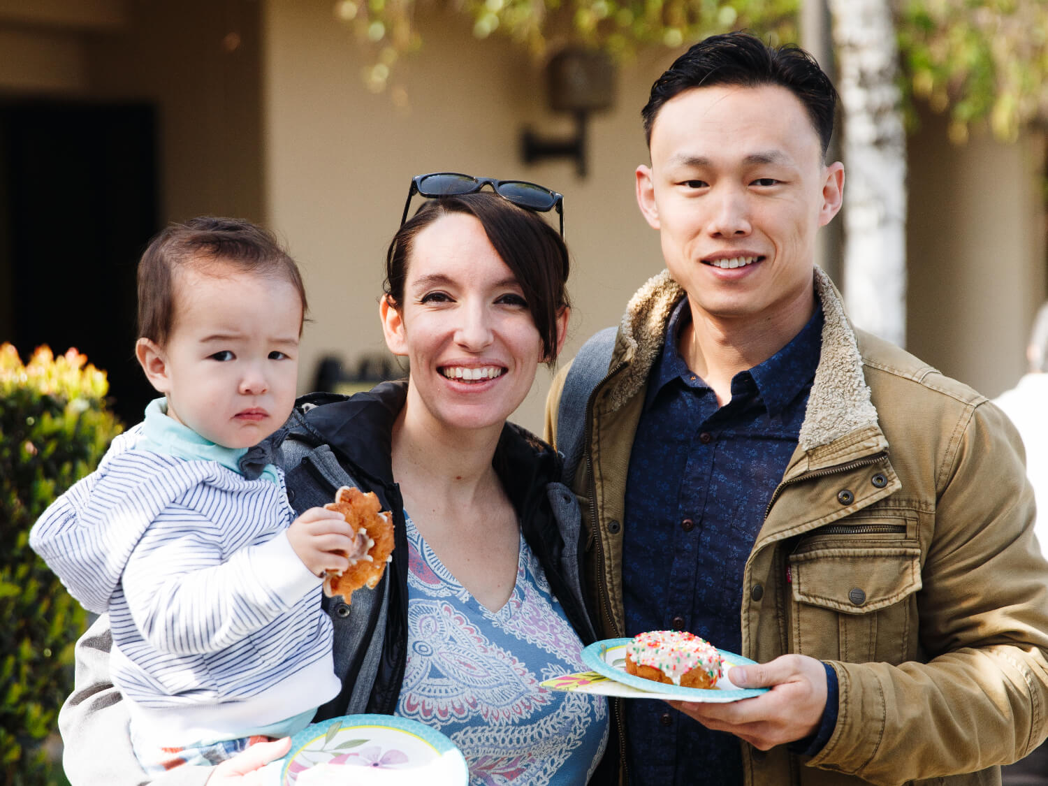 parents holding baby