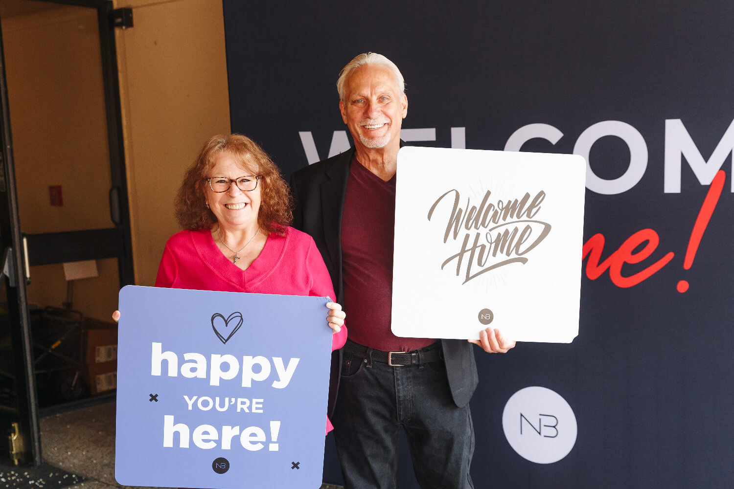 woman holding welcome sign